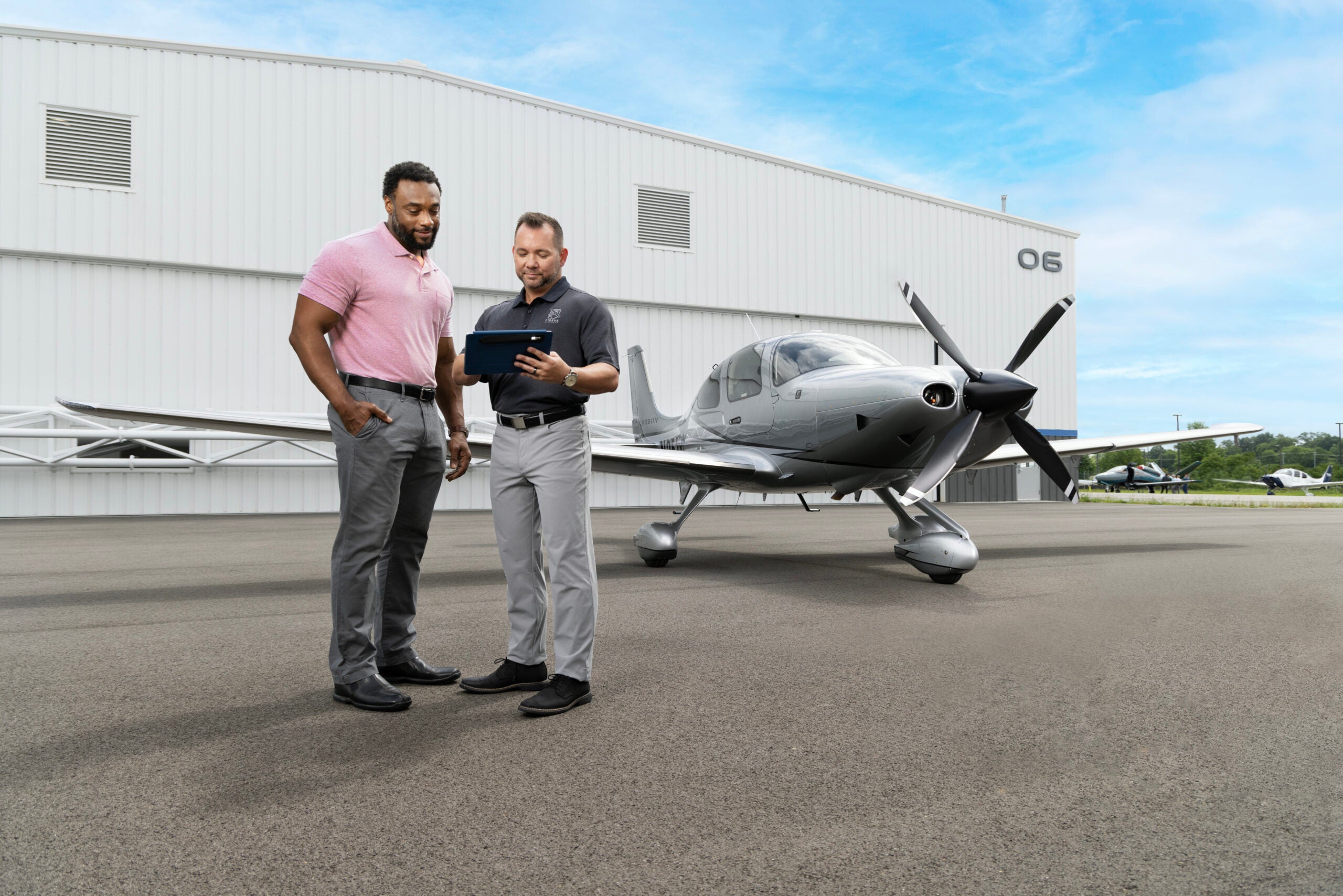 student with instructor in front of plane